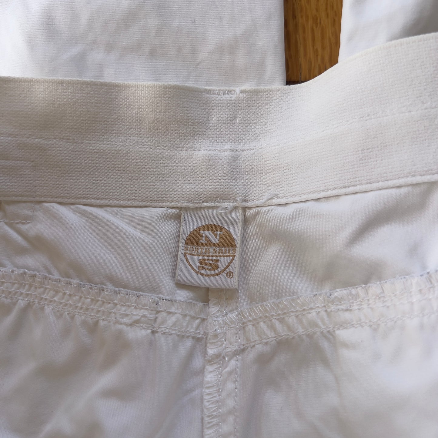 baggy white North Sails pants