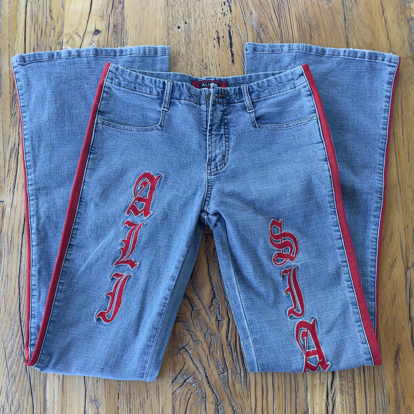 flared denim jeans with red detailing