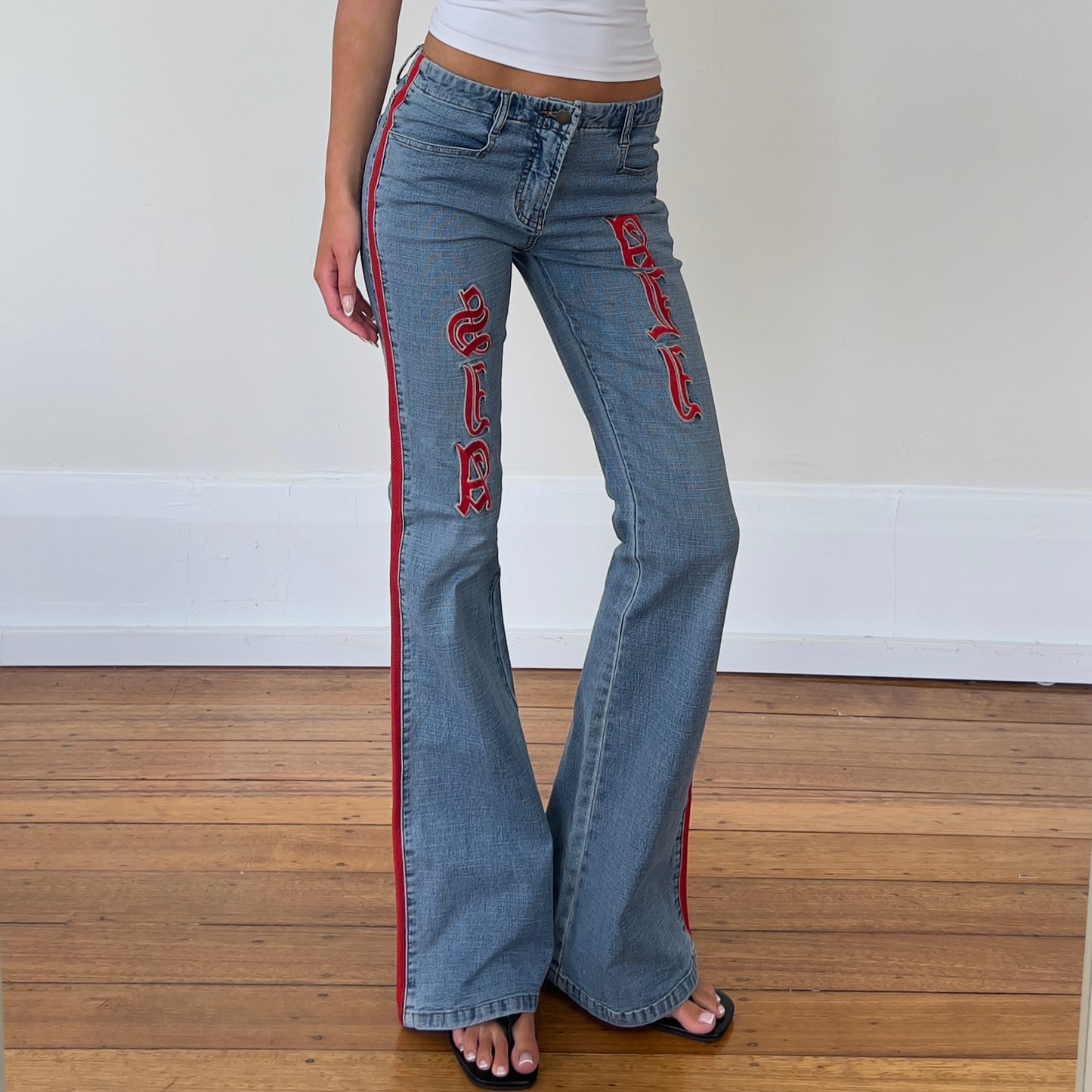 flared denim jeans with red detailing