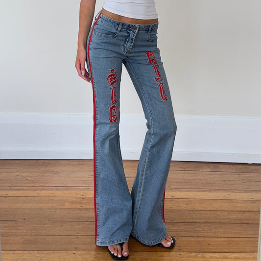 flared denim jeans with red detailing