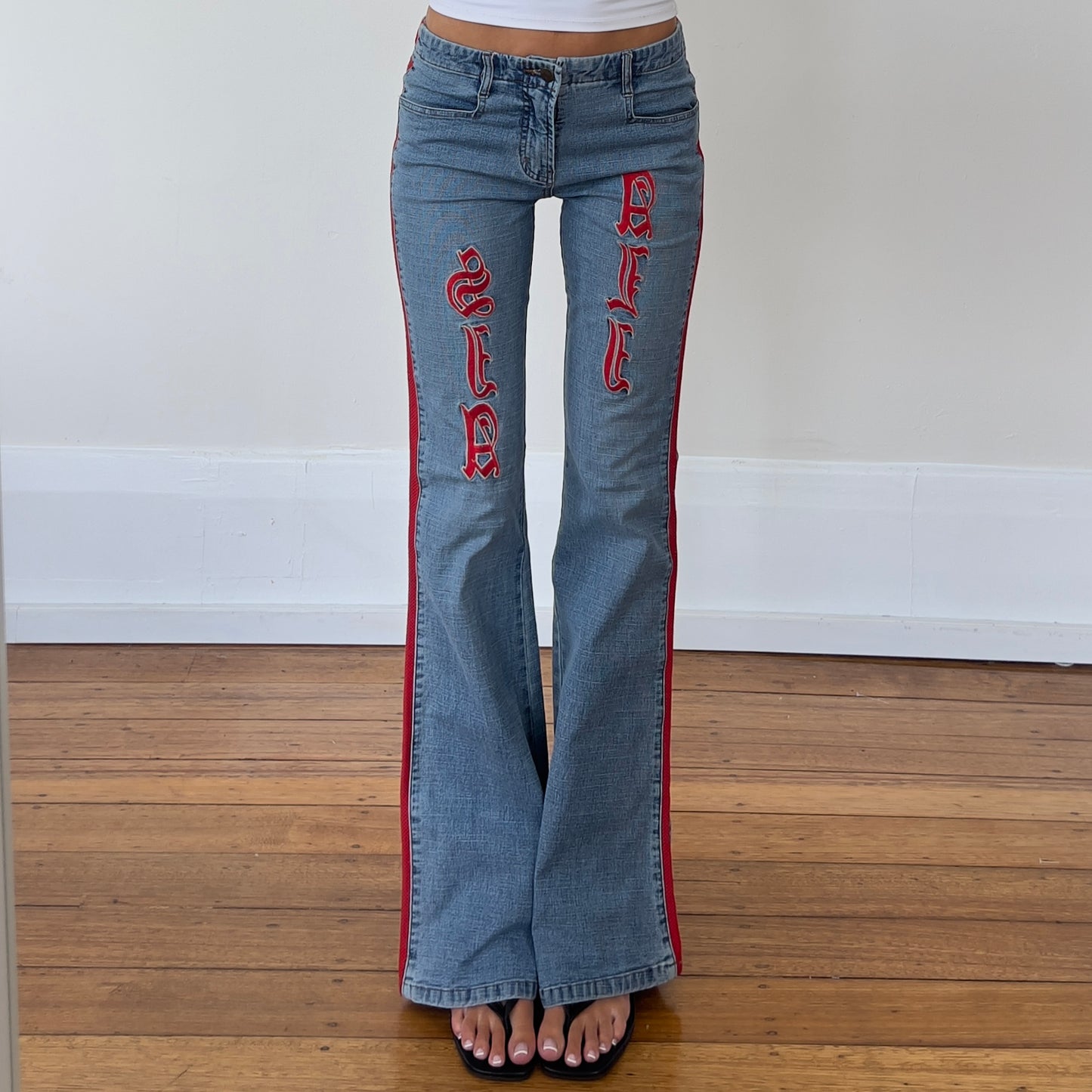 flared denim jeans with red detailing