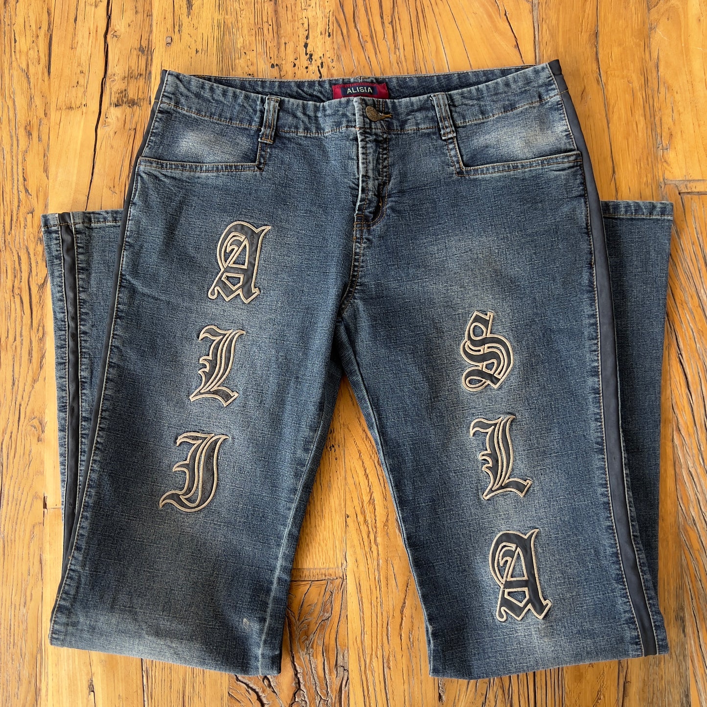 low rise flared stitched jeans