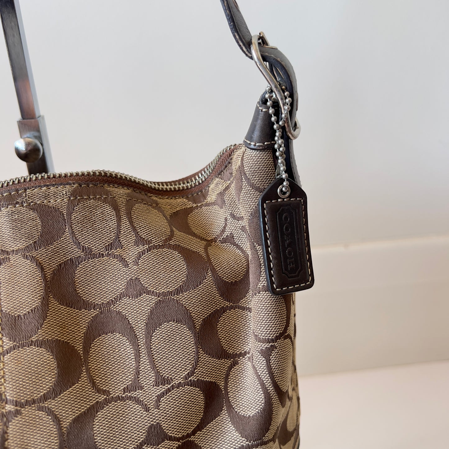 brown signature Coach hobo bag