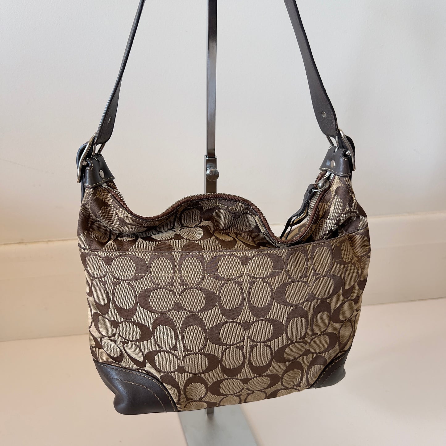 brown signature Coach hobo bag