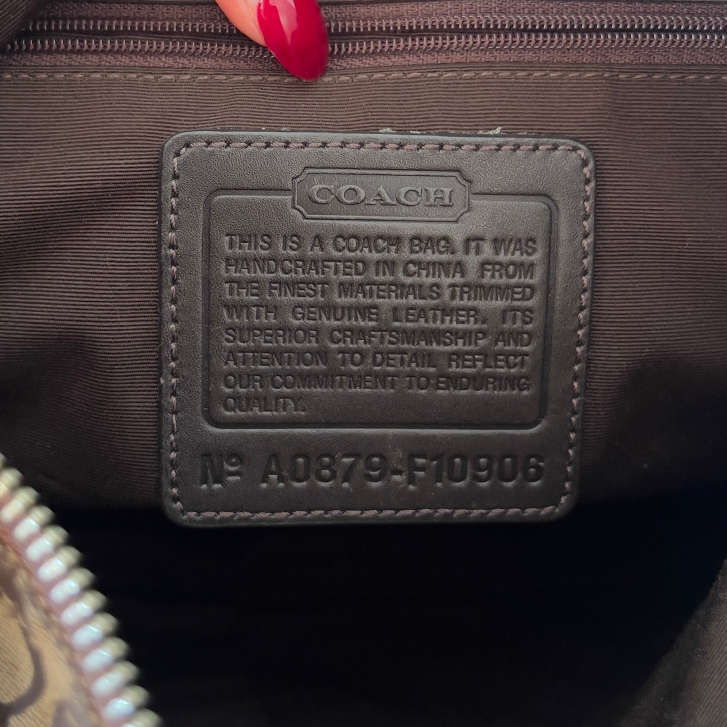 brown signature Coach hobo bag