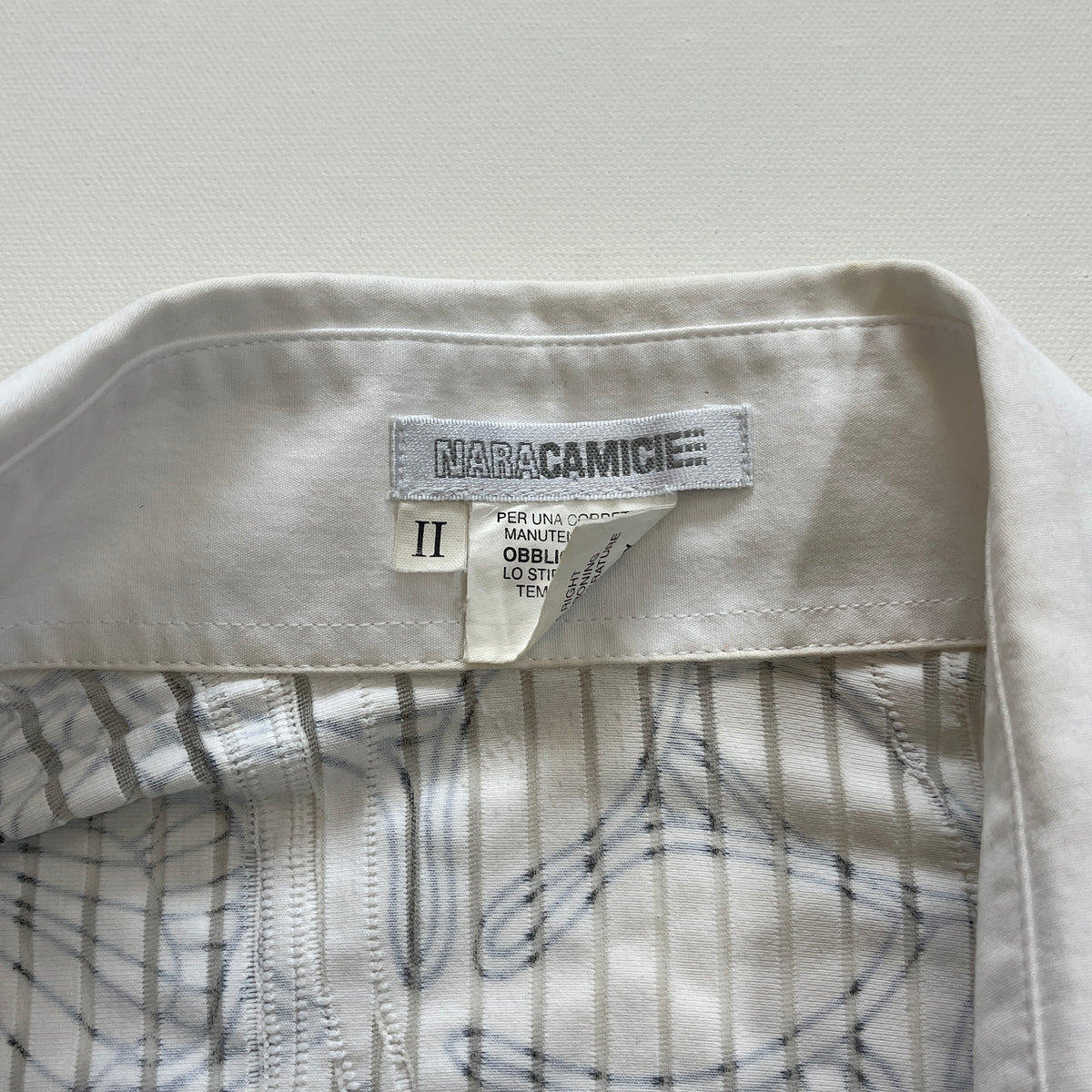 white graphic button-up shirt
