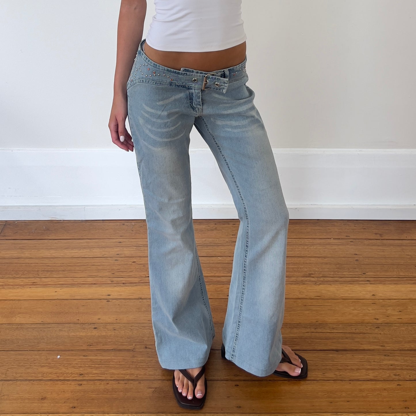 low rise flared buckle jeans