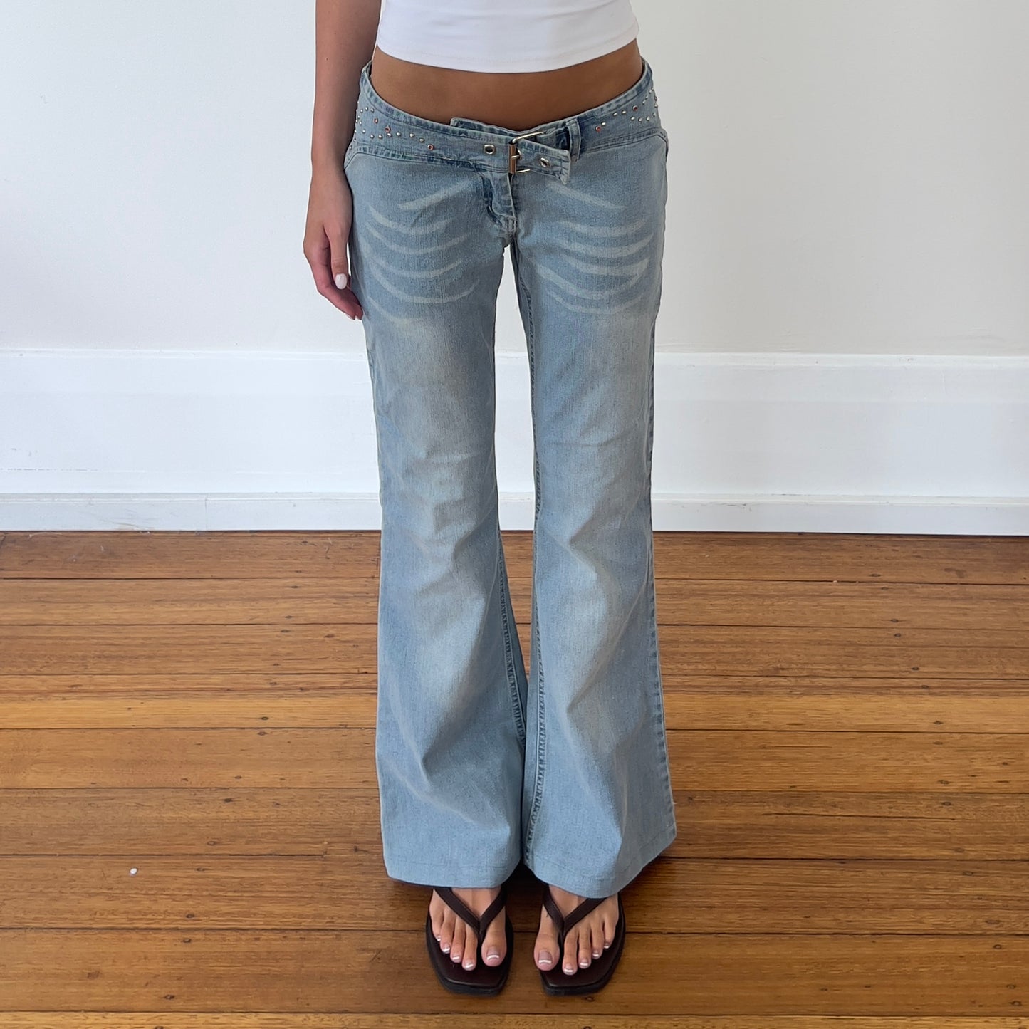 low rise flared buckle jeans
