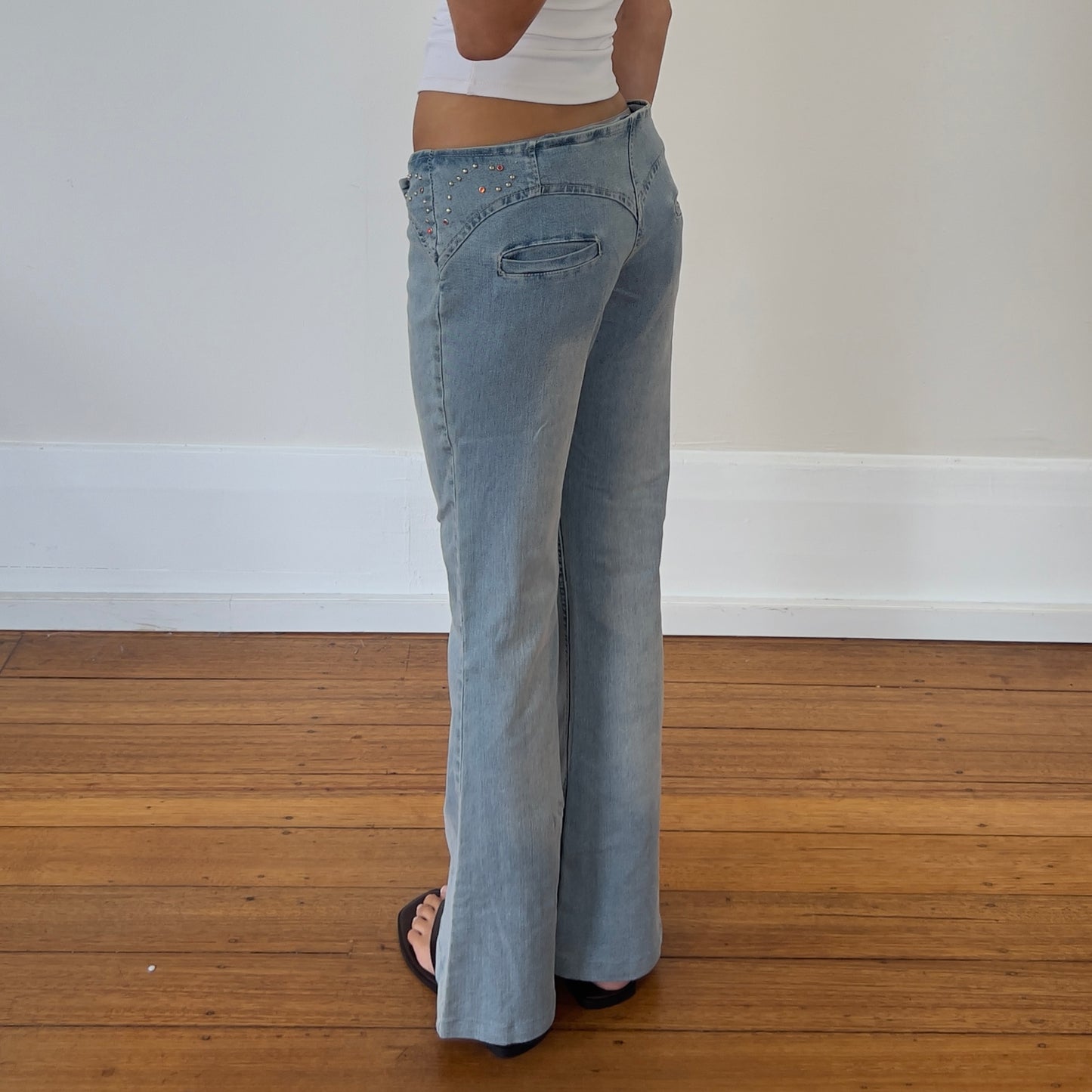 low rise flared buckle jeans